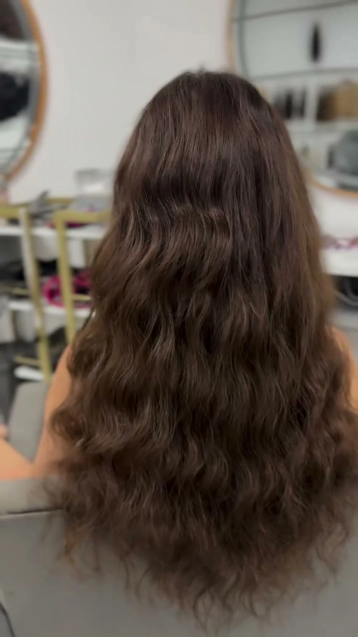The same Royal Hair Malta client with a longer brunette wavy result after the transformation
